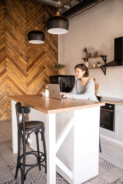 Woman at home, working online to start and operate a one person business