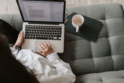 Writing on laptop, option to start and operate a one person business