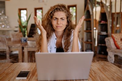 Woman frustrated at home with laptop