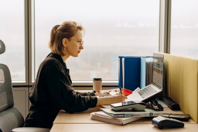 Accountant at computer is reference for bookkeeper