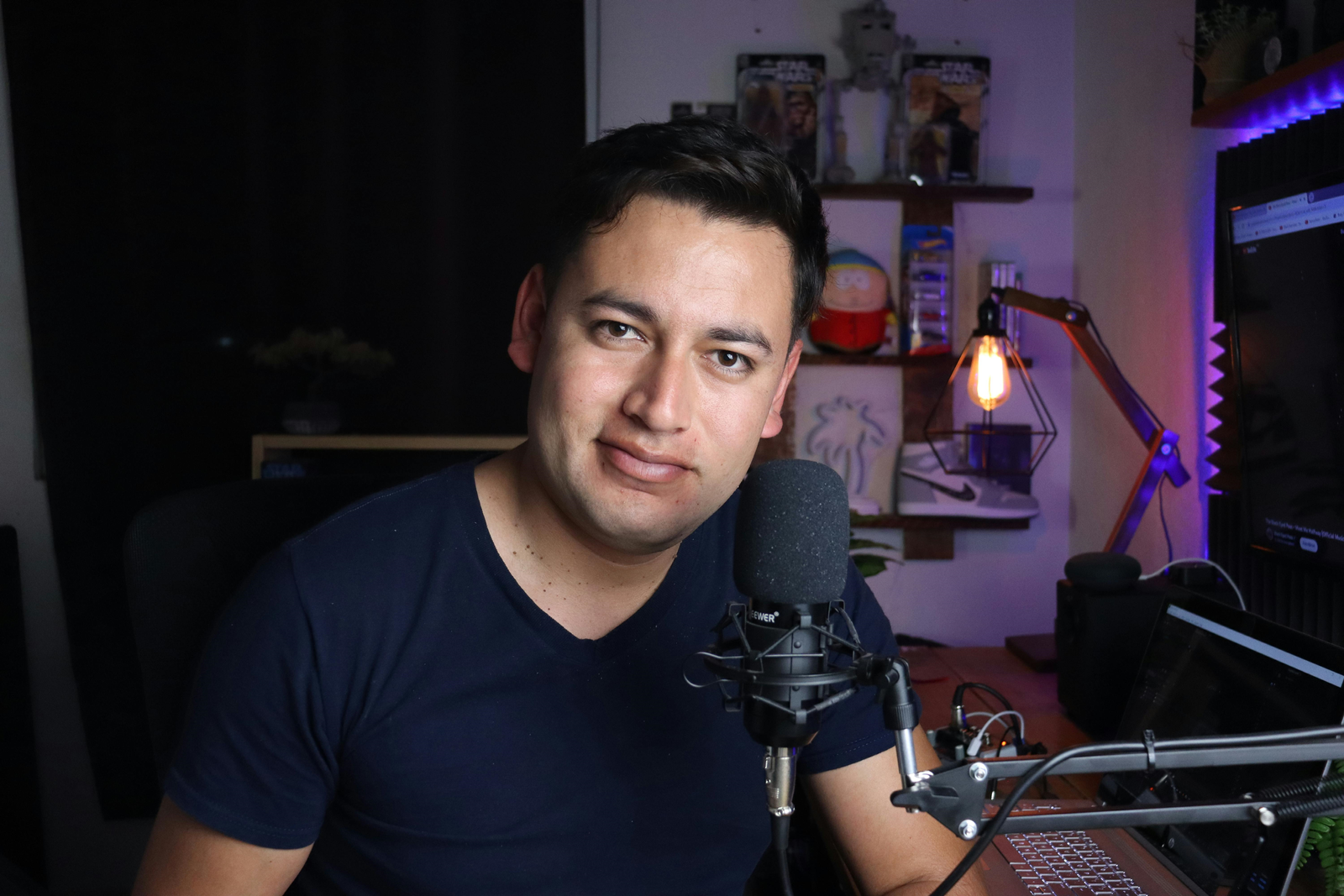 Young man preparing to record a podcast in his studio