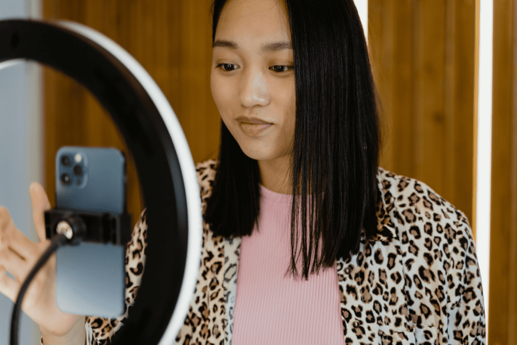 Young girl making a video for social media on her mobile phone.