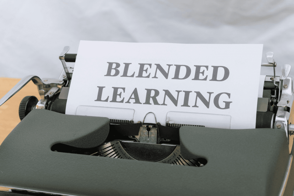 A typewriter with a page in it that spells the words blended learning