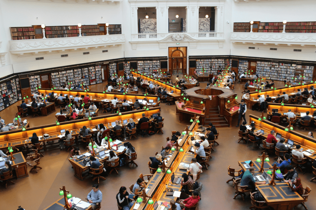 A college library that is filled with students reading